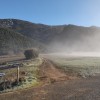 Pista hacia el Vallejo de la Hoz,justo enfrente de él Peña de las Cinco.